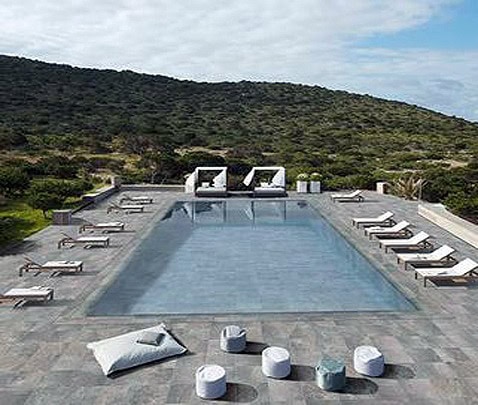 Piscina interrata con zona relax e vista panoramica sulle colline circostanti.